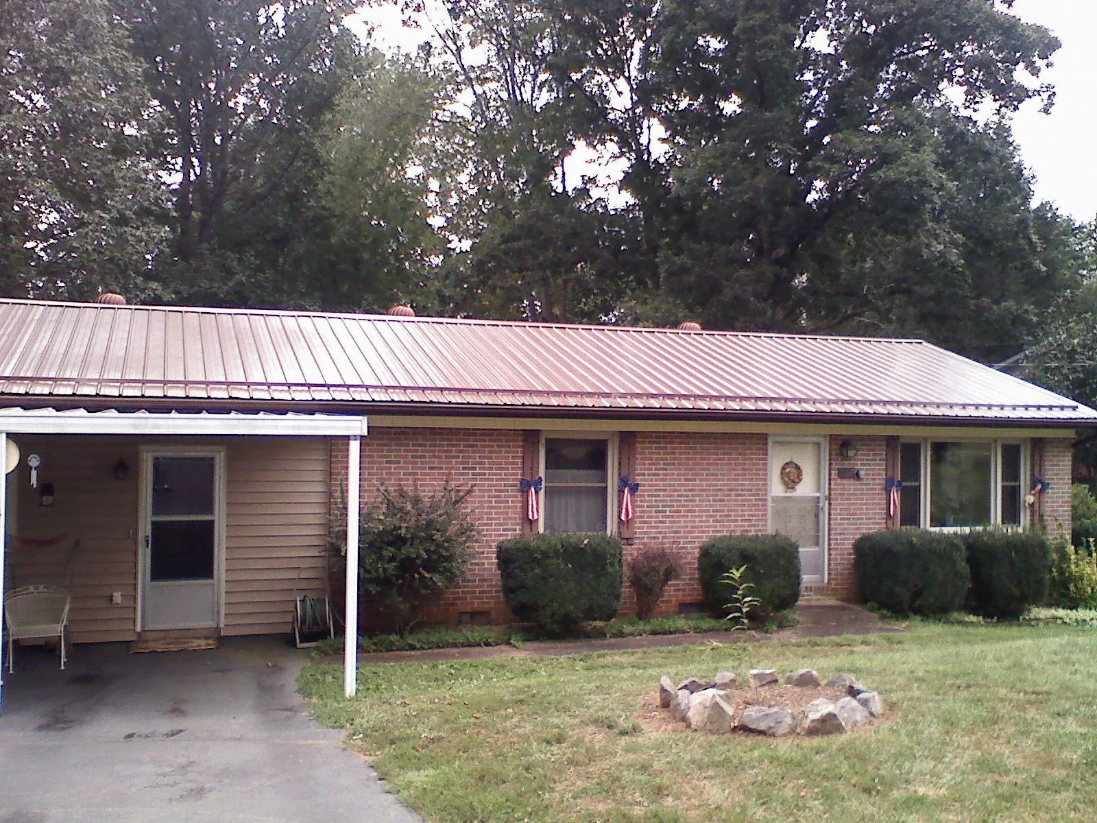 Bronze metal roof and carport on a brick ranch home — Roof Repair work by our crew in North Richland Hills