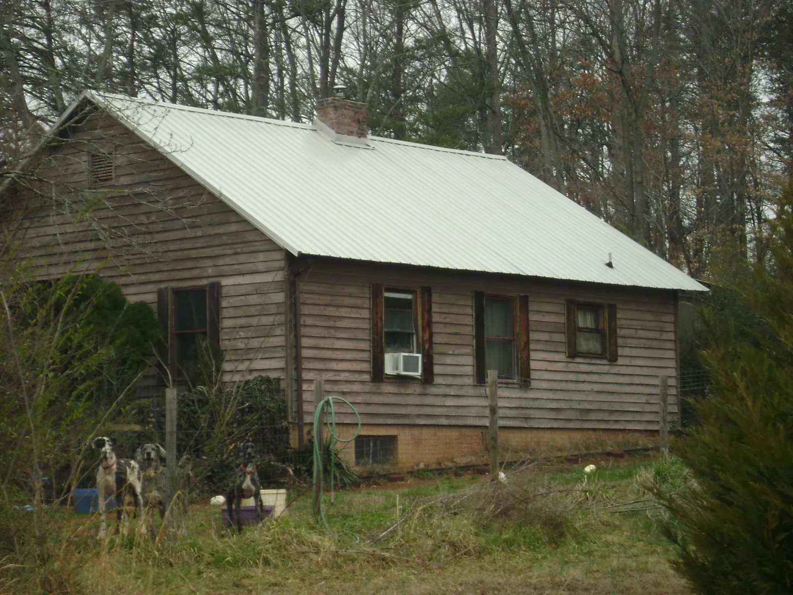 White metal roof on an old wood sided farmhouse, from a Asphalt Shingle Roof Repair job in North Richland Hills